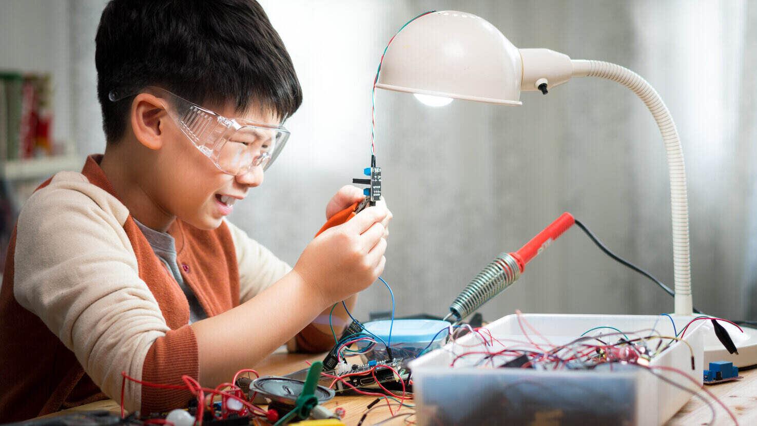 Student assembles circuits at table
