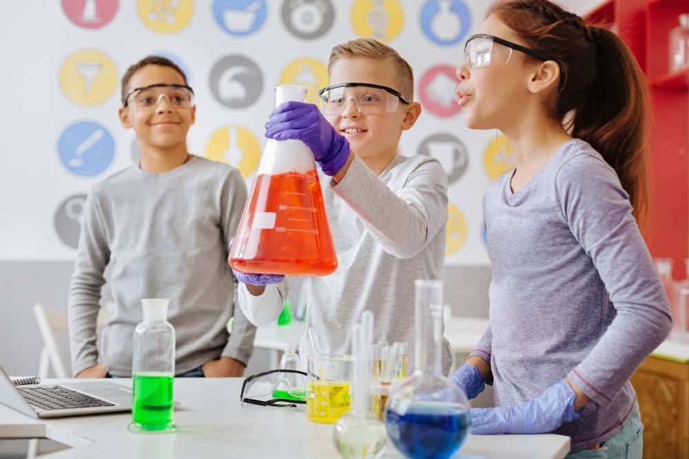 Teenagers performing chemistry experiment