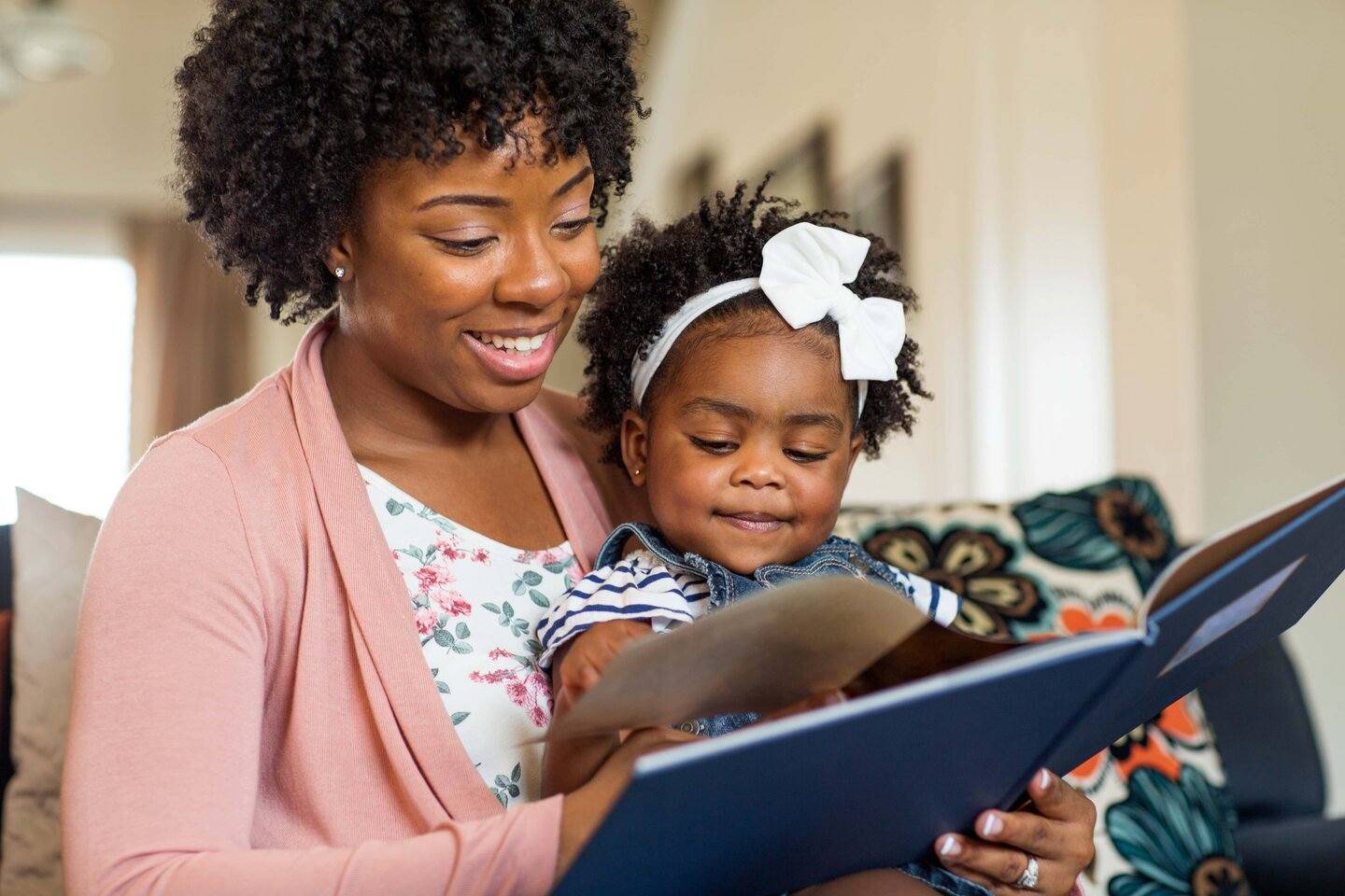 Image of mother holding baby with open book high school research project biochemistry