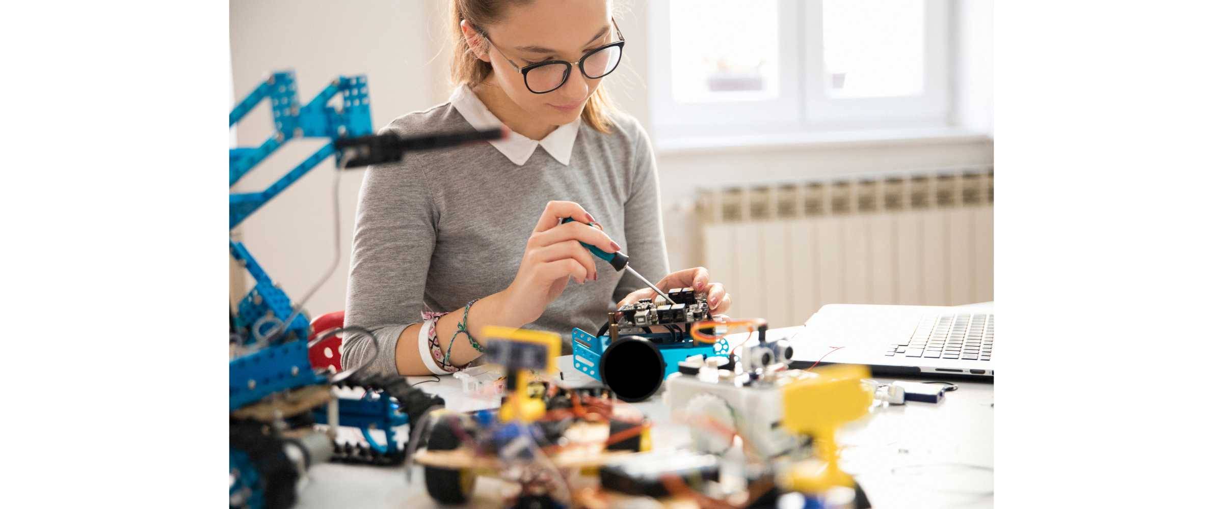 student wearing glasses working on a robotics passion project