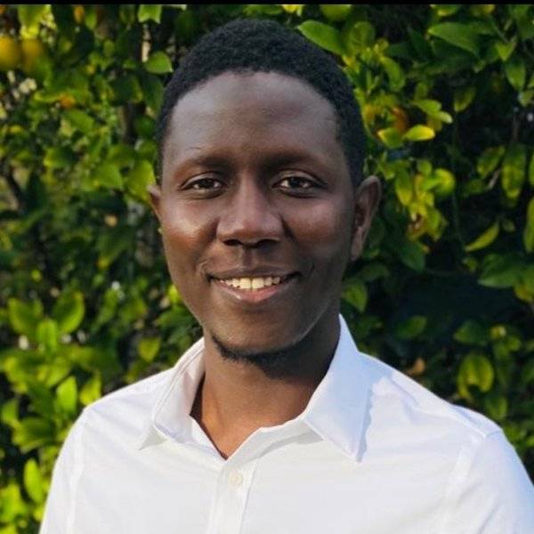 Smiling student outside in front of grass