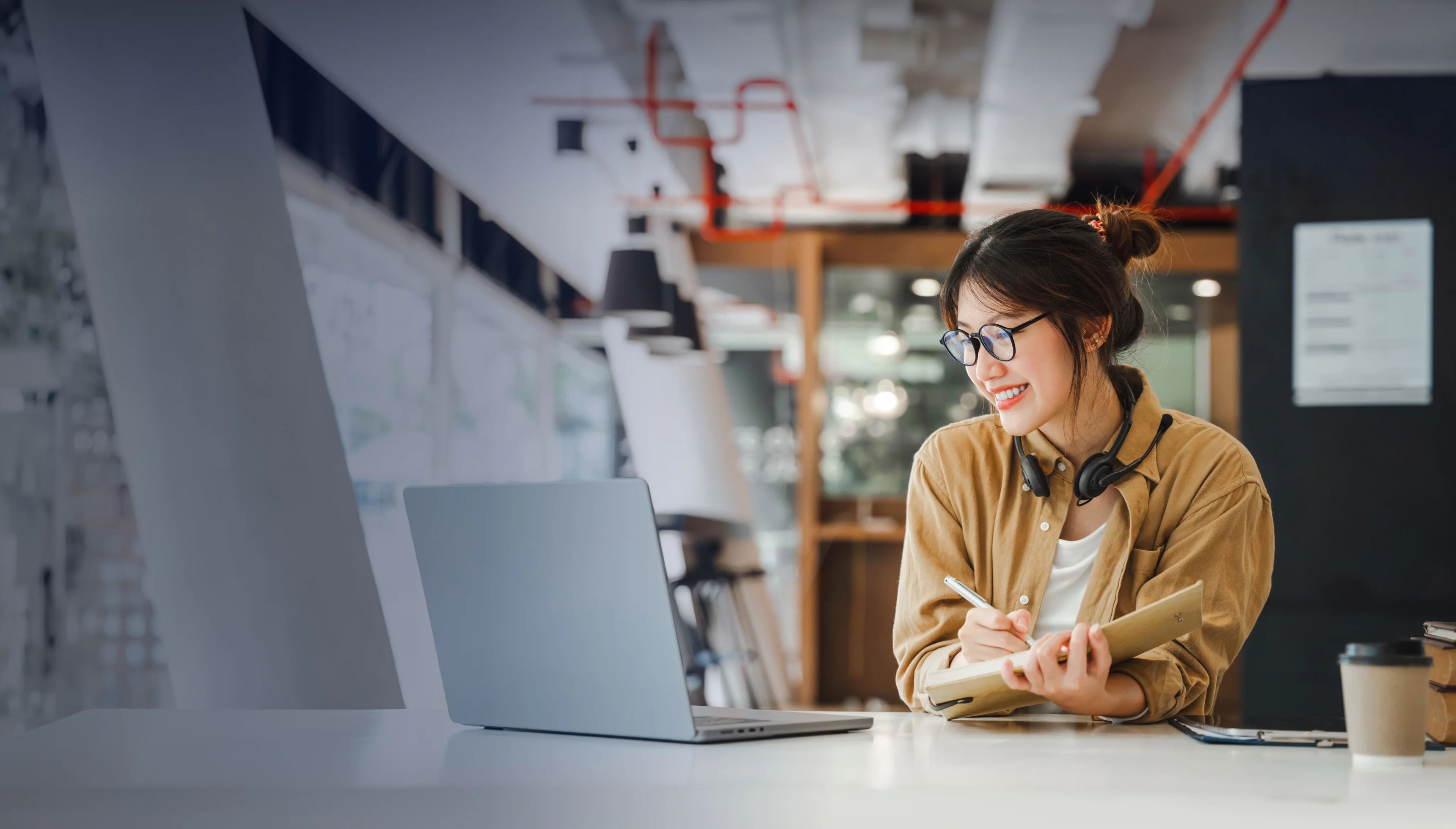 Happy female student working on her research project in an online session