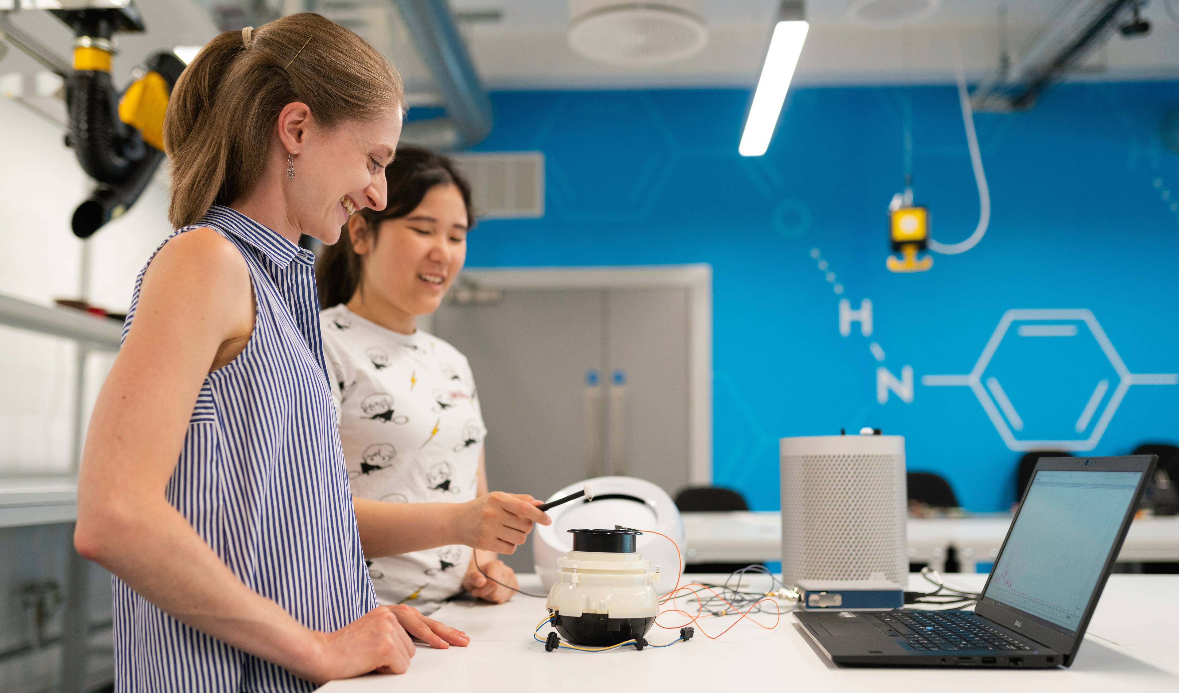 students with a robot in a lab