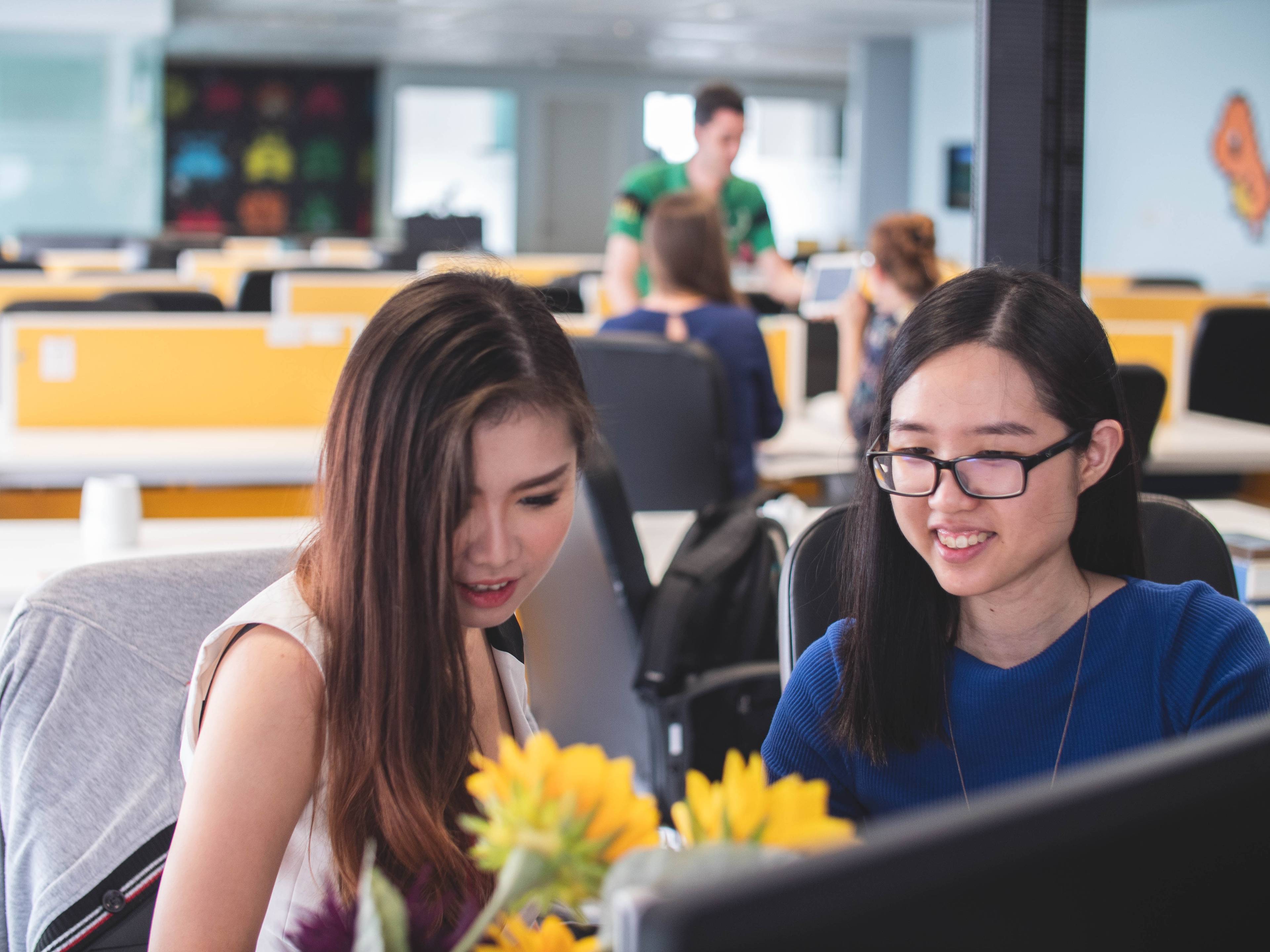 two women looking at a computer