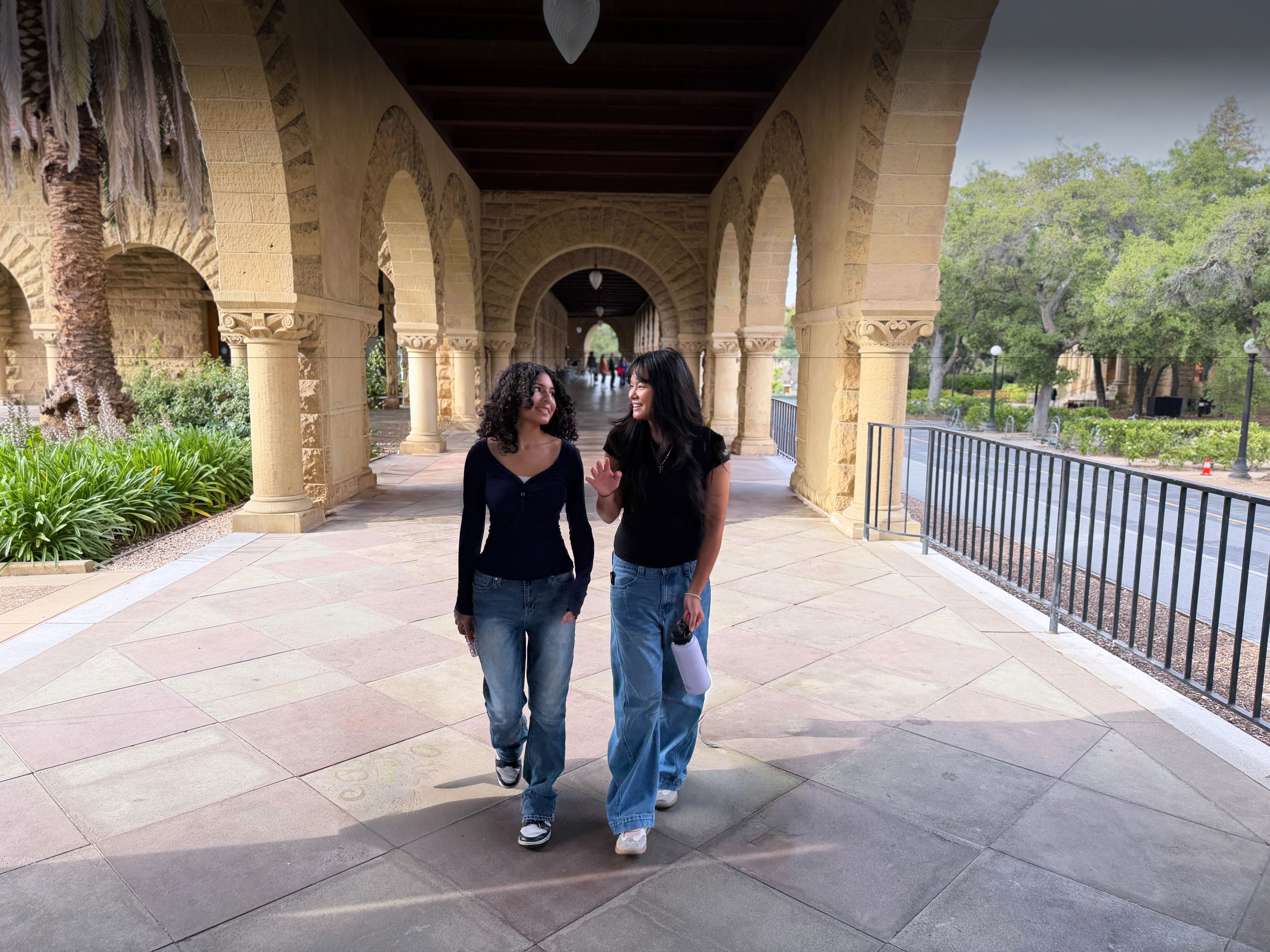 Two female student walking on a university campus