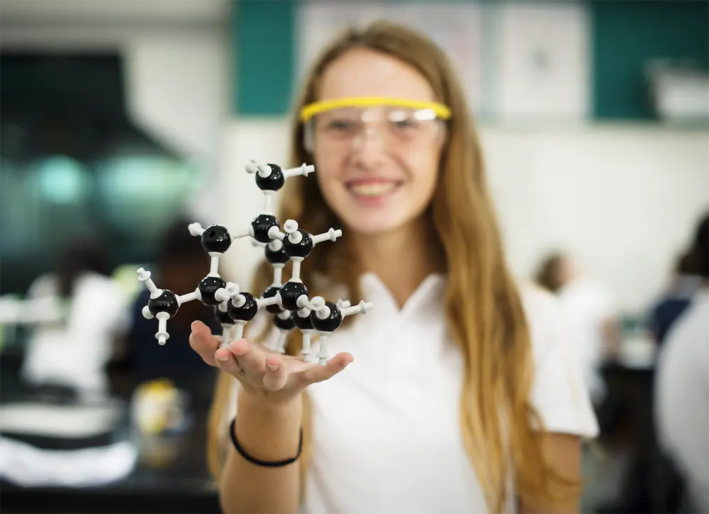 Female student at science fair showcasing her research