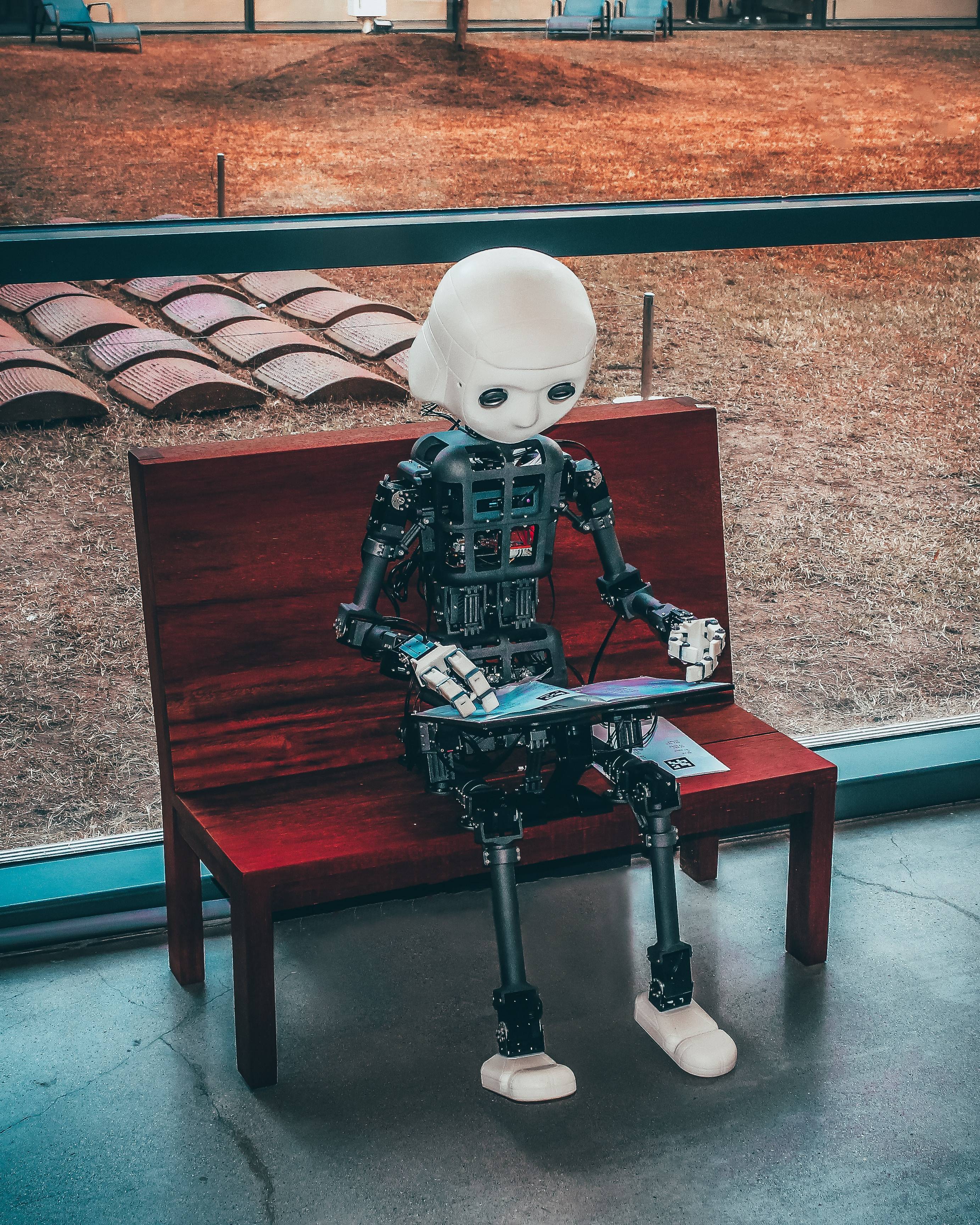 Black and white robot toy on red wooden table