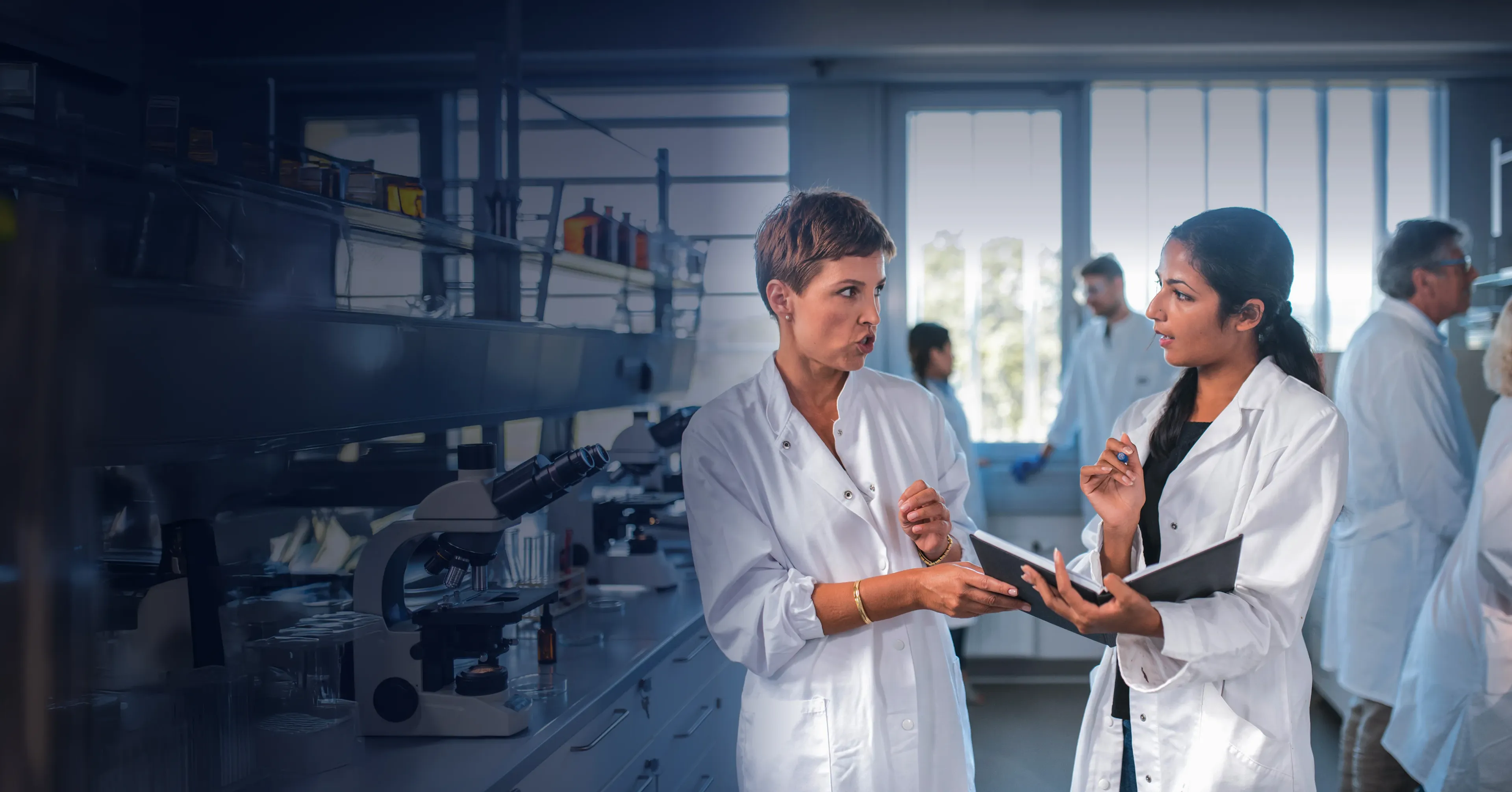 Two female scientist having a discussion in a lab